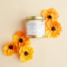 California golden poppy scented soy candle in a brushed gold tin with a wooden wick.